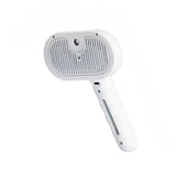 White pet grooming brush tool with ergonomic handle on white background